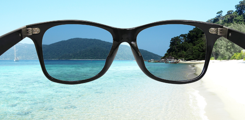 A visual example of polarised lenses reducing glare by the beach